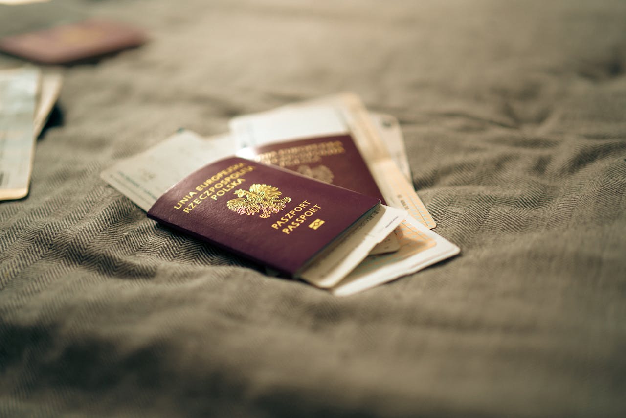 paszport polski leżący na łóżku z dokumentami